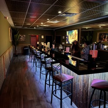 Bar stools along a long counter inside a South Florida kava bar
